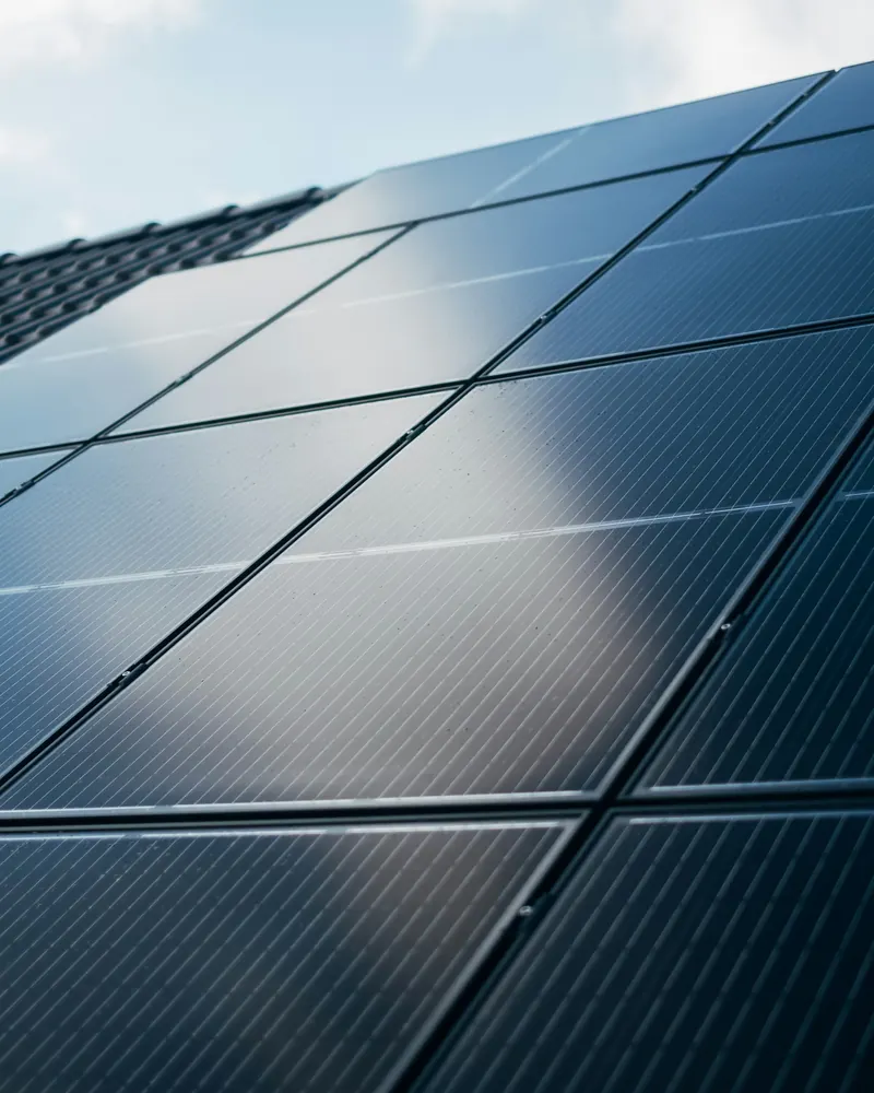 Close-up of dark solar panels on a building catching the sunlight
