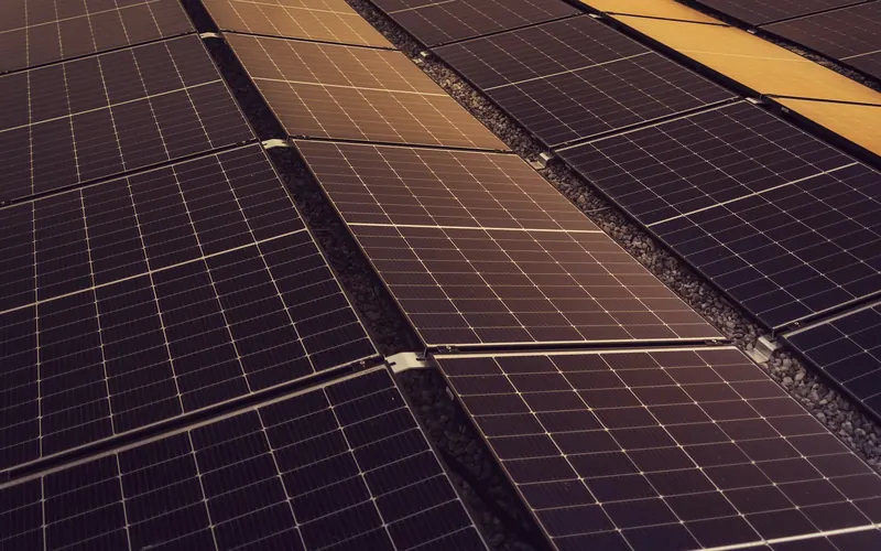 Rows of solar panels installed across a large industrial roof